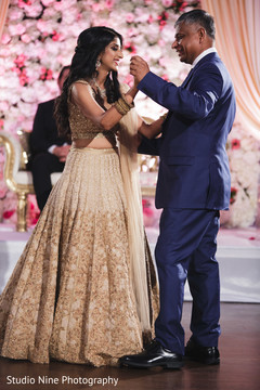 Cute Indian bride dancing with her father. Cute Indian bride dancing with her father.