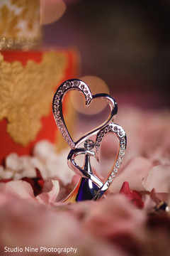 Indian wedding cake table silver hearts decoration. Indian wedding cake table silver hearts decoration.