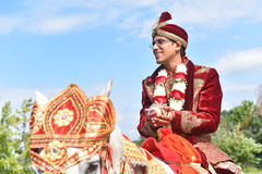 Charming groom riding on his white baraat horse. Charming groom riding on his white baraat horse.