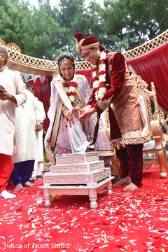 Indian bride and groom throwing the rice together in to fire. Indian bride and groom throwing the rice together in to fire.