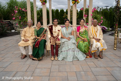 Adorable Indian bride and groom posing with family. Adorable Indian bride and groom posing with family.