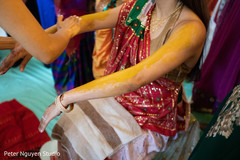 Maharani getting the turmeric paste all over. Maharani getting the turmeric paste all over.