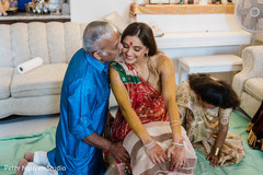 Indian bride being kiss by her father at the Haldi party. Indian bride being kiss by her father at the Haldi party.