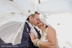 Lovely Indian groom kissing bride photo session. Lovely Indian groom kissing bride photo session.