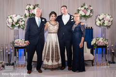 Adorable Indian bride and groom posing with family members. Adorable Indian bride and groom posing with family members.