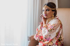 Indian bride getting her earrings on. Indian bride getting her earrings on.