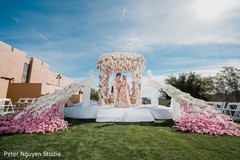 Indian bride and groom at fascinating mandap flowers decoration. Indian bride and groom at fascinating mandap flowers decoration.