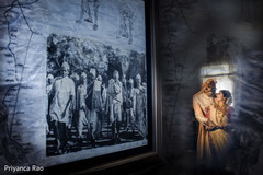 Beautiful shot of Indian newlyweds by a painting from Gandhi Beautiful shot of Indian newlyweds by a painting from Gandhi