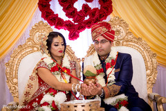 Maharani and groom holding the coconut ritual. Maharani and groom holding the coconut ritual.