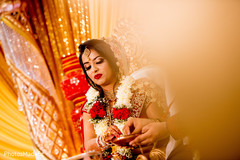 Indian bride capture at the pouring of rice to sacred fire. Indian bride capture at the pouring of rice to sacred fire.