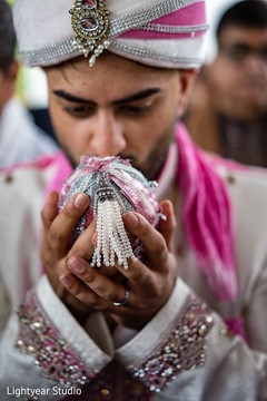 Indian groom holding the coconut capture. Indian groom holding the coconut capture.