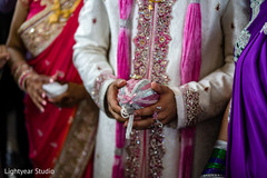 Closeup capture of the groom holding the coconut. Closeup capture of the groom holding the coconut.