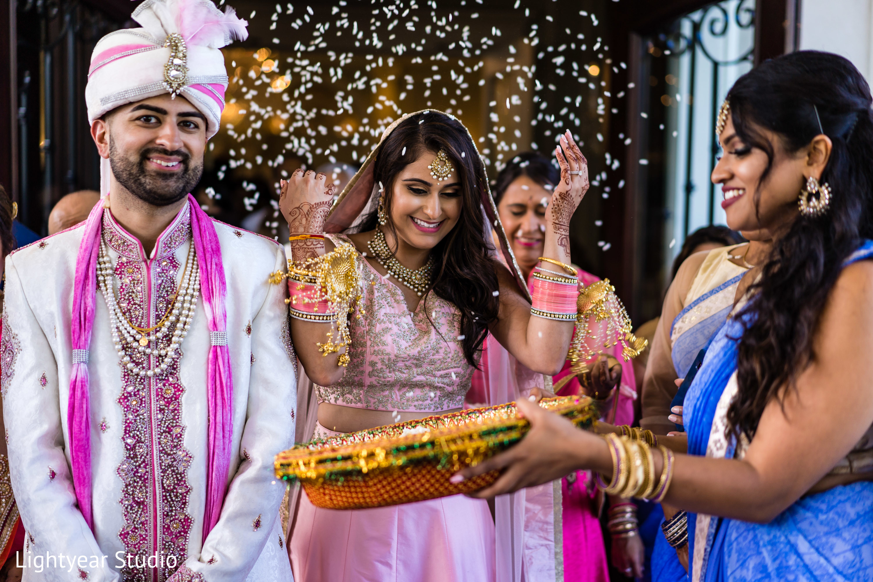 Indian bride throwing rice on her back out of ceremony. Photo 213761