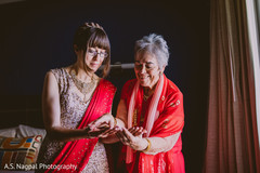 Indian bride and relative admiring henna art. Indian bride and relative admiring henna art.