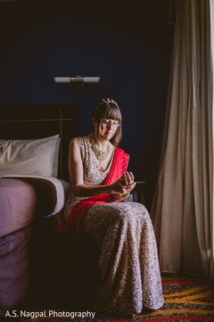Lovely Indian bride putting her jewelry on. Lovely Indian bride putting her jewelry on.