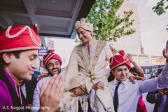 Elegant Indian groom lifted by groomsmen capture. Elegant Indian groom lifted by groomsmen capture.