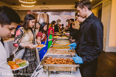 Indian wedding guests having their buffet dinner. Indian wedding guests having their buffet dinner.