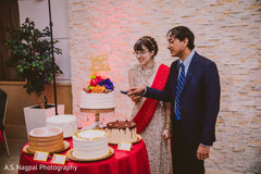 Indian bride and groom cutting cake moment. Indian bride and groom cutting cake moment.