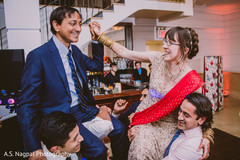 Indian bride and groom being lift up by groomsmen. Indian bride and groom being lift up by groomsmen.