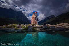 Amazing shot of Indian bride and groom by the river Amazing shot of Indian bride and groom by the river