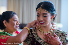 Indian bride being assisted by special guests prior to the ceremony Indian bride being assisted by special guests prior to the ceremony