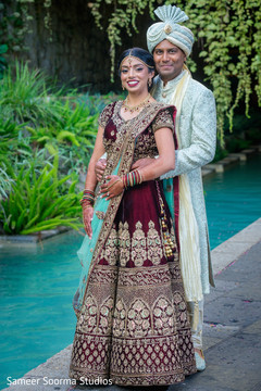 Indian bride and groom posing for the photo shoot Indian bride and groom posing for the photo shoot