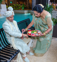 Indian groom being blessed by special guest Indian groom being blessed by special guest