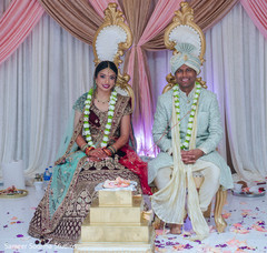 Indian bride and groom posing under the decor Indian bride and groom posing under the decor