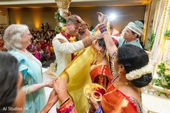 Indian groom being uncovered from antarpat. Indian groom being uncovered from antarpat.