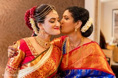 Lovely Indian bride being kiss by her mother. Lovely Indian bride being kiss by her mother.