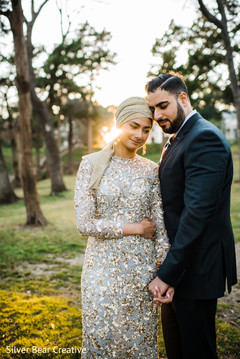 Elegant Indian bride and groom posing outdoors for photo. Elegant Indian bride and groom posing outdoors for photo.