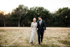 Adorable Indian couple walking holding hands. Adorable Indian couple walking holding hands.
