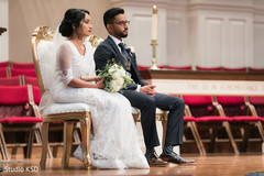 Indian bride and groom listening to the officiant Indian bride and groom listening to the officiant