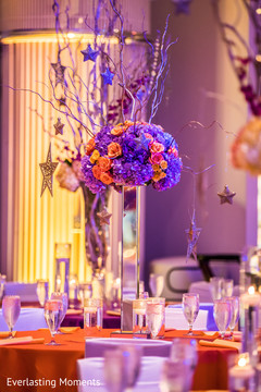 Orange and purple Indian wedding table centerpiece. Orange and purple Indian wedding table centerpiece.