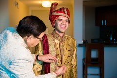 Indian groom being assisted by special guest Indian groom being assisted by special guest