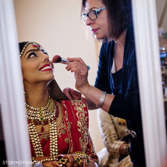 Lovely Indian bride getting her makeup done. Lovely Indian bride getting her makeup done.