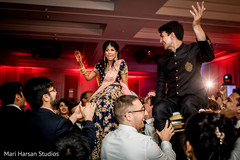 Indian newlyweds being lifted by joyful guests Indian newlyweds being lifted by joyful guests