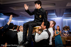 Indian groom being lifted by guests Indian groom being lifted by guests