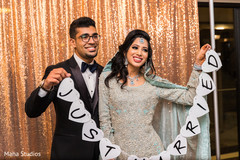 Indian couple posing with a just married sign. Indian couple posing with a just married sign.