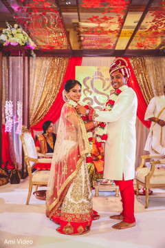 Indian bride and groom at their garland exchange ritual. Indian bride and groom at their garland exchange ritual.