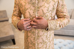 Indian groom getting ready with the sherwani Indian groom getting ready with the sherwani