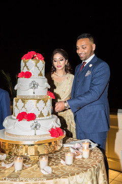 Indian bride and groom cutting the cake Indian bride and groom cutting the cake