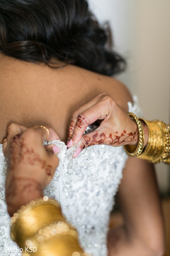 Indian bride getting her dress on. Indian bride getting her dress on.