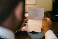 Indian groom reading a note from bride before ceremony. Indian groom reading a note from bride before ceremony.