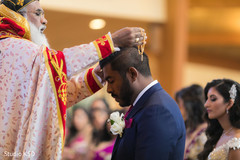 Charming Indian groom receiving blessings from priest. Charming Indian groom receiving blessings from priest.