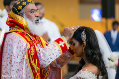 Charming Indian bride receiving blessings from priest. Charming Indian bride receiving blessings from priest.