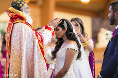 Maharani getting praying from Christian priest. Maharani getting praying from Christian priest.