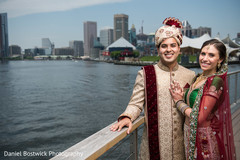 Indian bride and groom posing by the water Indian bride and groom posing by the water