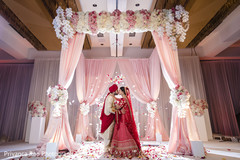 Indian bride and groom under the mandap Indian bride and groom under the mandap