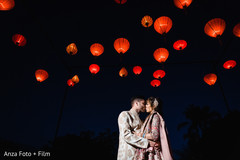 Indian couple kissing under the lights Indian couple kissing under the lights